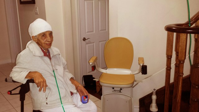 Mrs. Gill next to her new Stair lift!